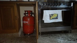 The gas canister is just like one on a gas grill only bigger and it fits under a cabinet . Most people don't have an oven, just a stove range, so the canister goes right under the burners.